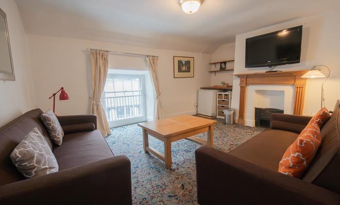 living room with 2 sofas, coffee table, fire place and tv